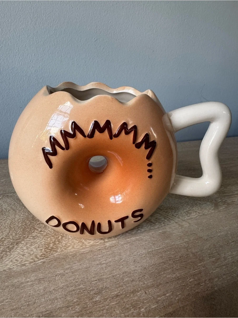 Donut-Shaped Ceramic Mug with Black Frosting and Tan Body